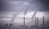 Water vapour from power stations in Europe. Limits on emissions from power plants have been weakened due to industry lobbying, says Greenpeace.